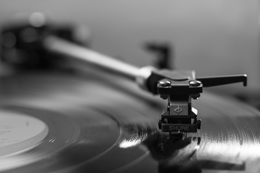 Needle resting on album on a record player black and white